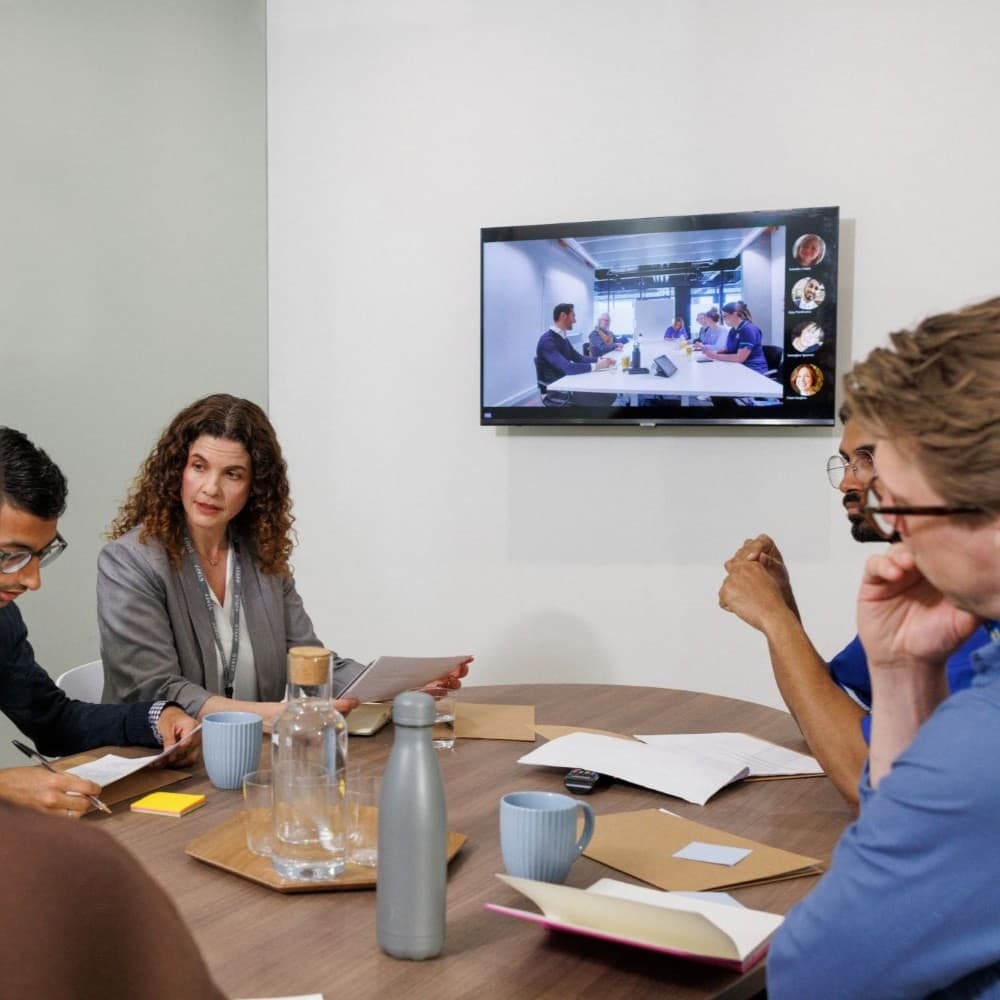 A team of doctors reviewing a patient's medical file.